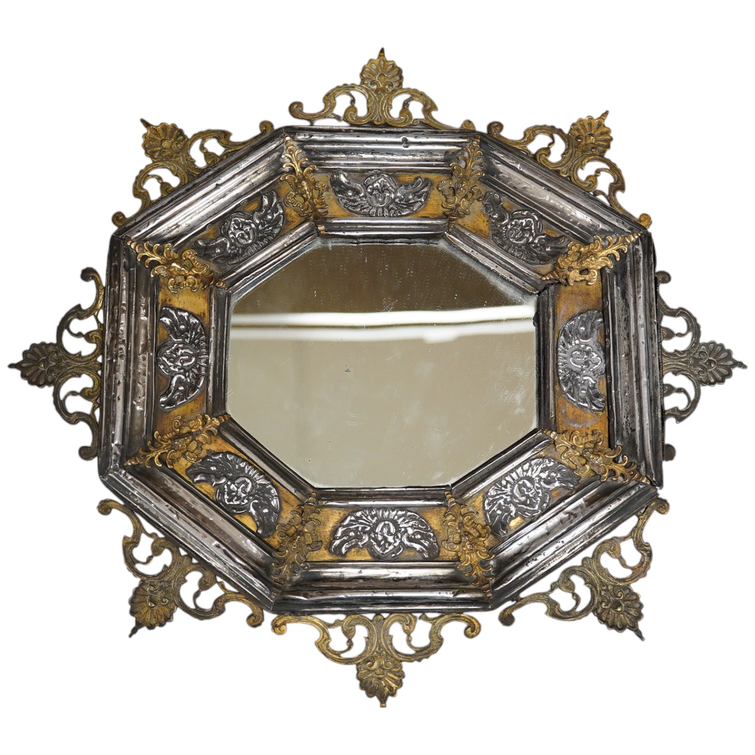 An octagonal white metal and brass mirror, 34cm wide. Condition - fair